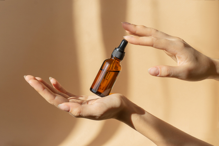 a bottle of serum in a womans hands